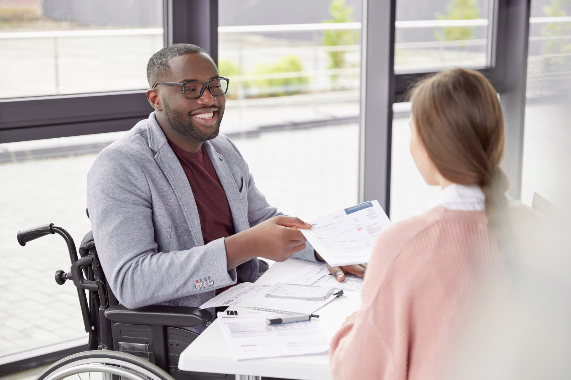 Jeune homme en fauteuil roulant dans un bureau